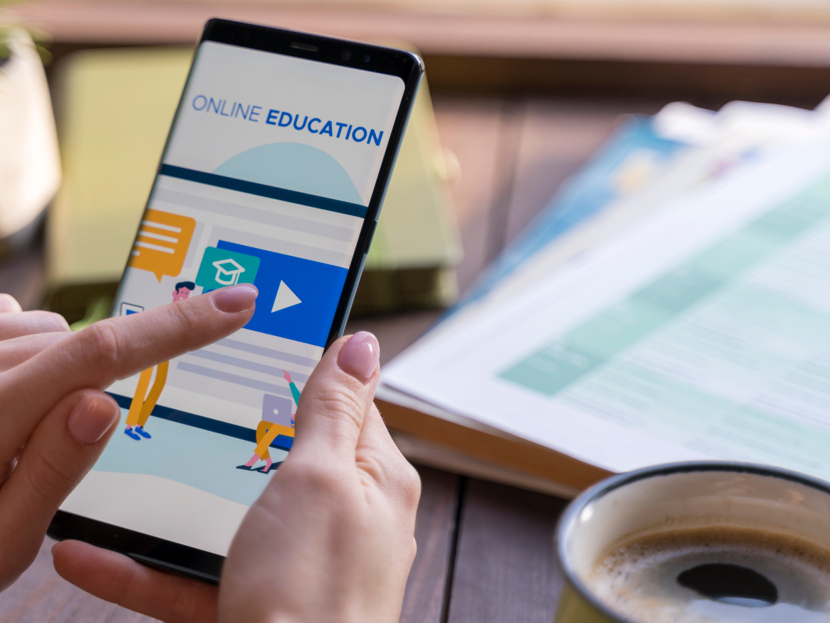 Person clicking on mobile education app