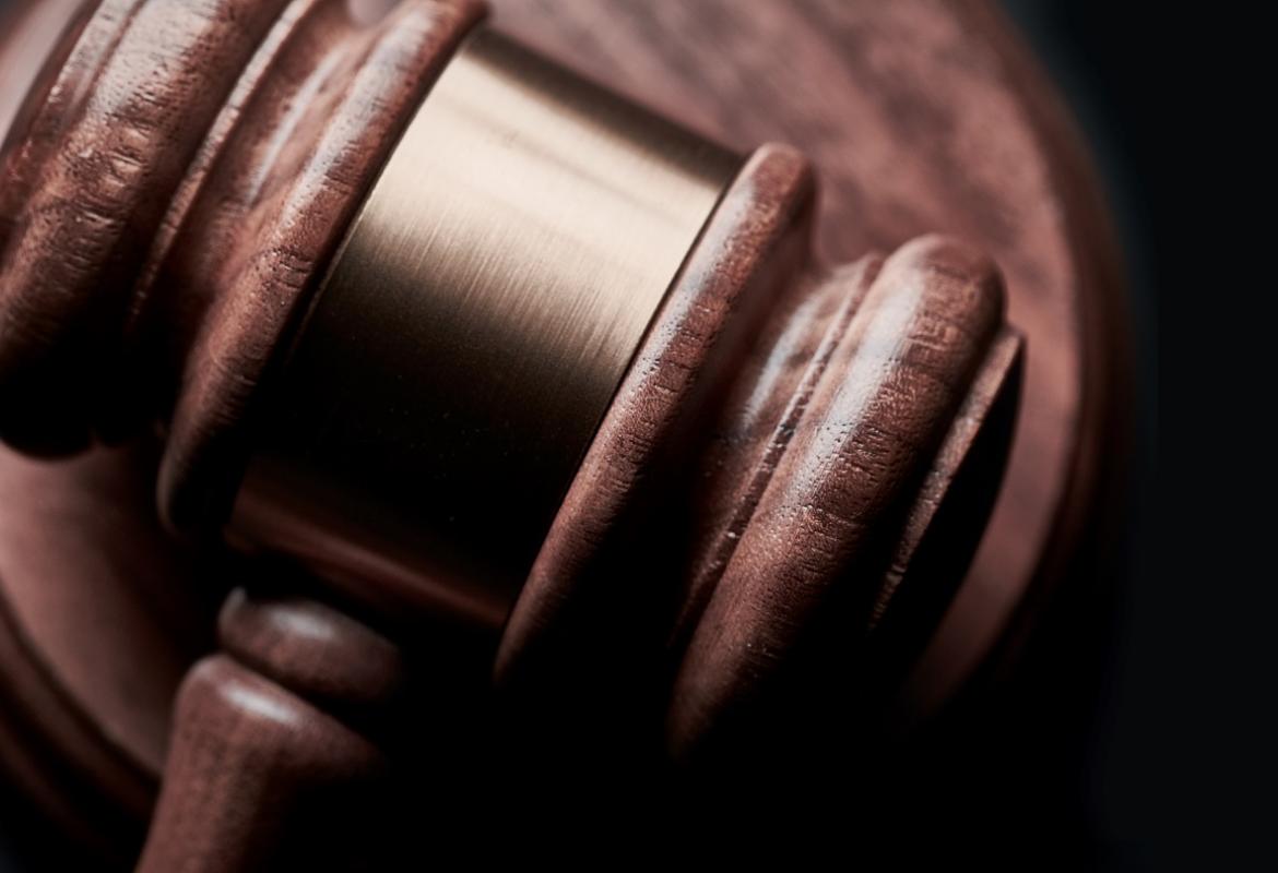 A gavel with a black background