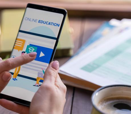 Person clicking on mobile education app