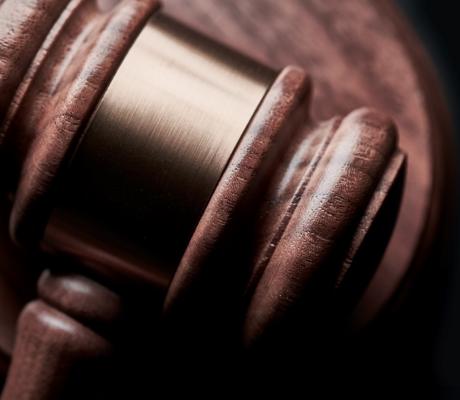 A gavel with a black background